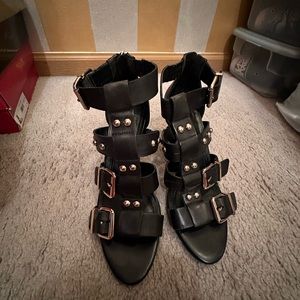 Black sandals with gold studs buckle across the top, zips in back. Size 81/2.